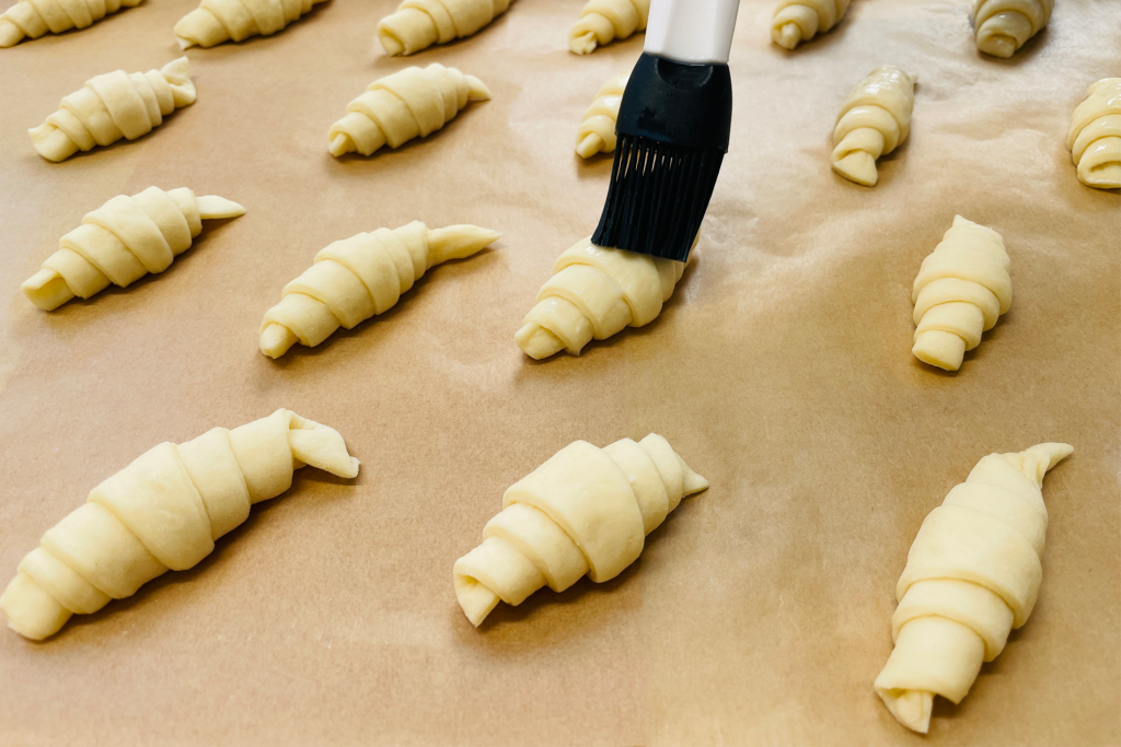 Application of Burolac Glaze 001 on croissants before baking